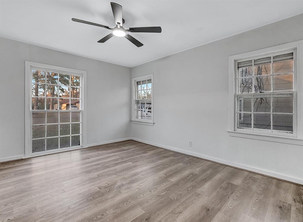 828 Unity Drive Wake Village, TX 75501 - Photo 11 of 14 an empty room with windows and ceiling fan
