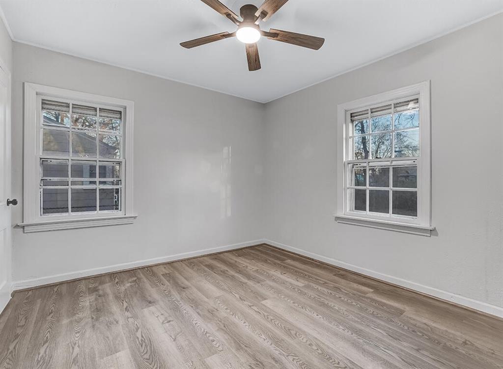 828 Unity Drive Wake Village, TX 75501 - Photo 12 of 14 a view of an empty room with a window and wooden floor