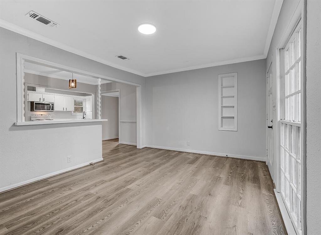828 Unity Drive Wake Village, TX 75501 - Photo 6 of 14 a view of a room with wooden floor and white walls