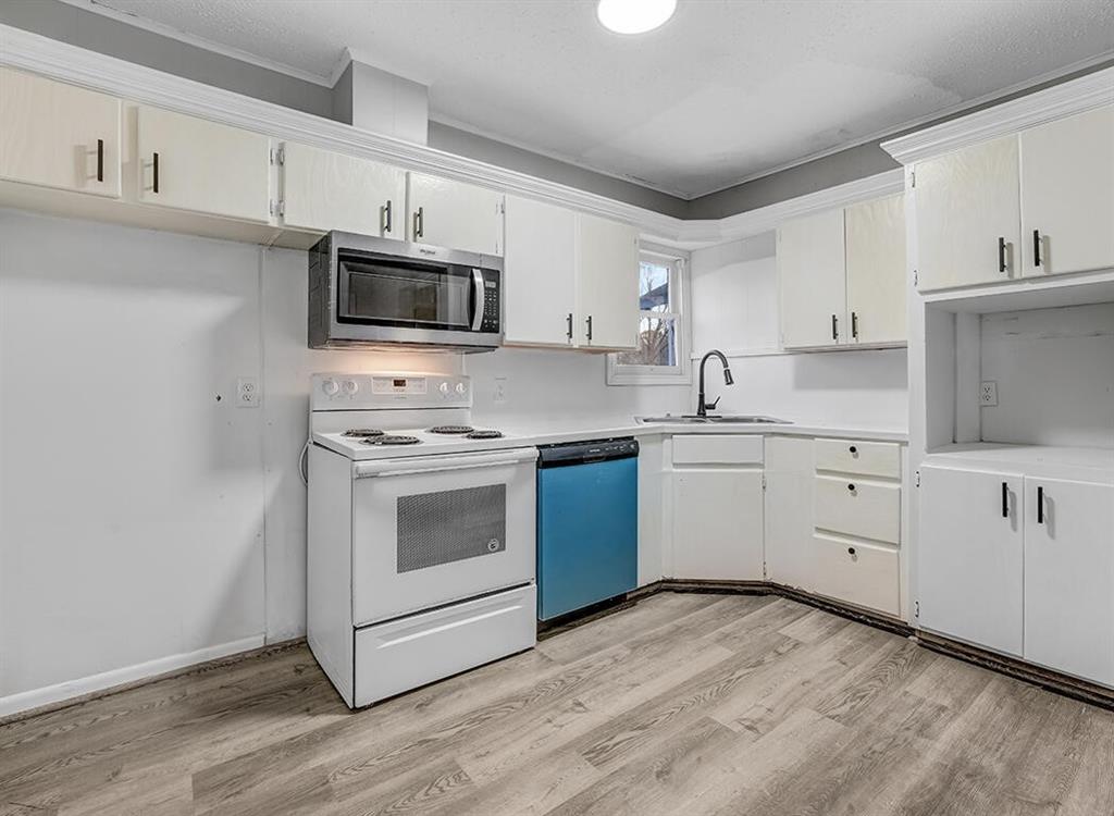 828 Unity Drive Wake Village, TX 75501 - Photo 8 of 14 a kitchen with white cabinets stainless steel appliances and sink