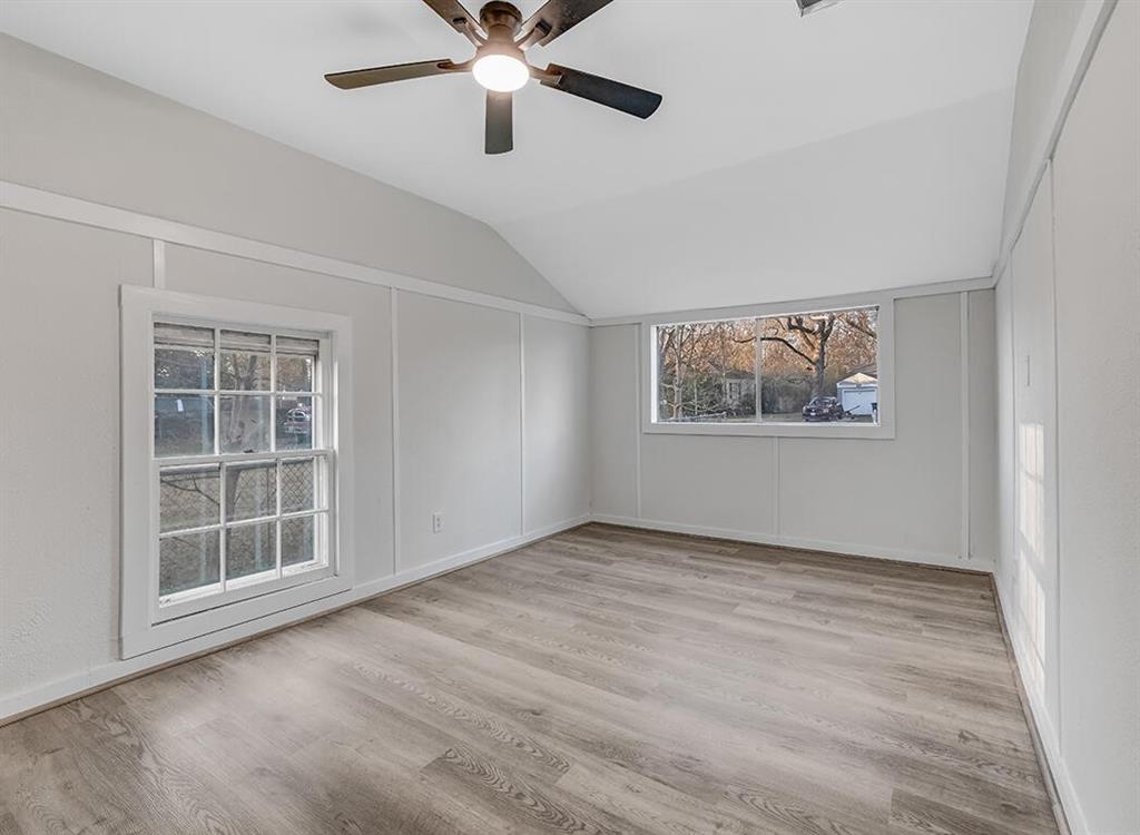 828 Unity Drive Wake Village, TX 75501 - Photo 10 of 14 a view of an empty room with a window and wooden floor