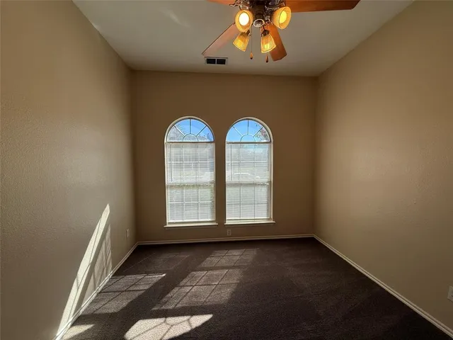 an empty room with a empty space and windows