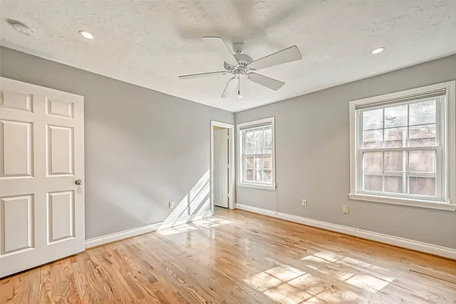 a bathroom with a granite countertop sink a toilet and a mirror