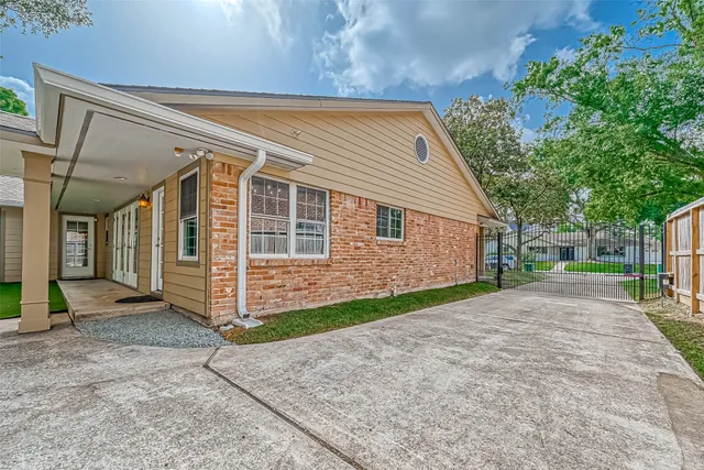 a view of a house with a yard and sitting area