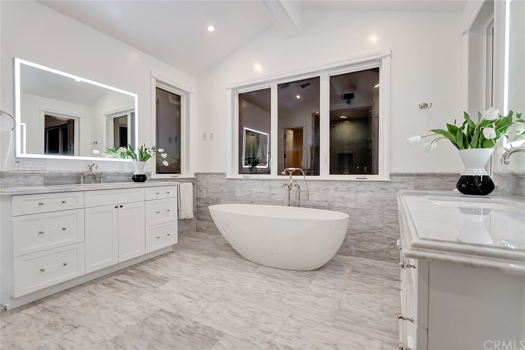 1751 8th Street Manhattan Beach, CA 90266 - Photo 36 of 43 a spacious bathroom with double vanity sinks a tub and a mirror