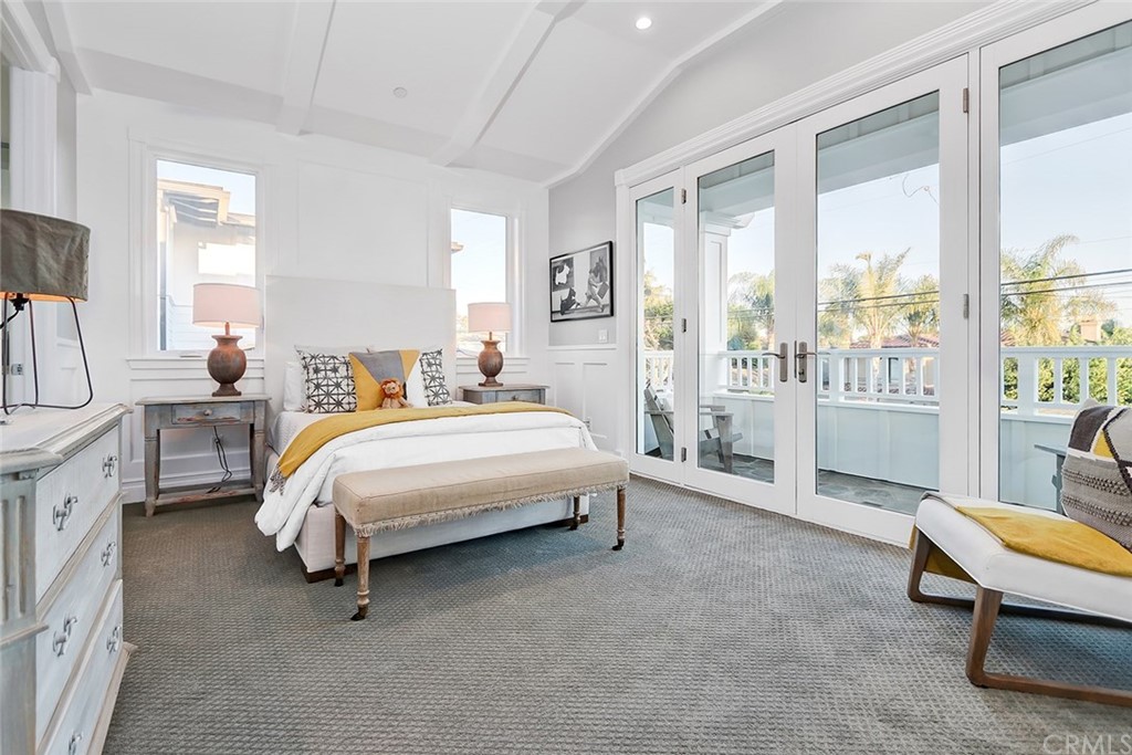 1751 8th Street Manhattan Beach, CA 90266 - Photo 38 of 43 a spacious bedroom with a bed a table and painting