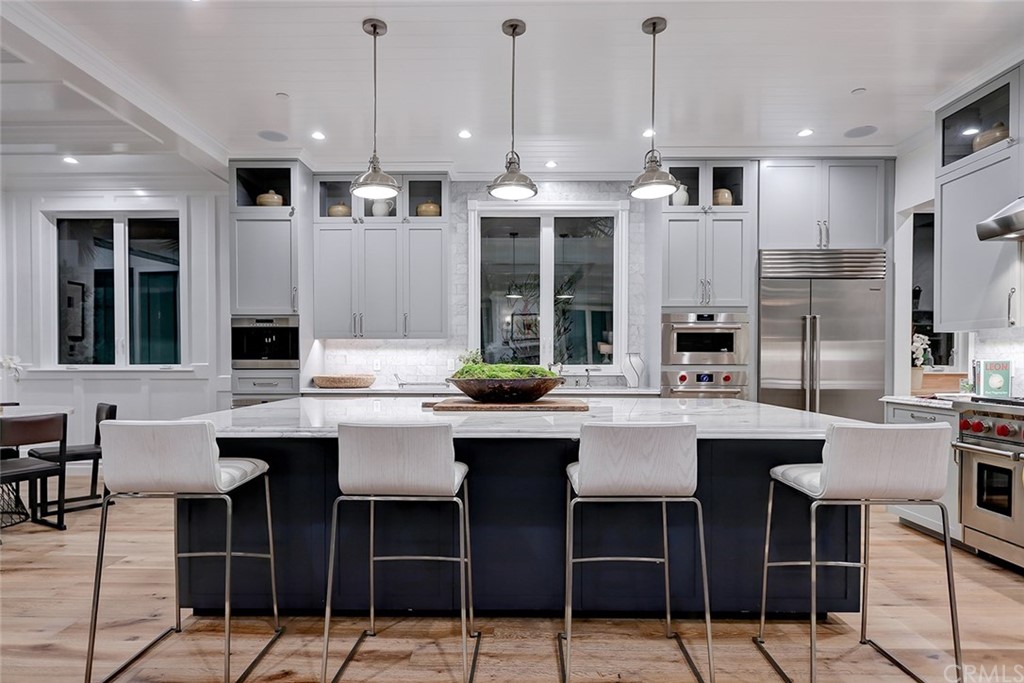 1751 8th Street Manhattan Beach, CA 90266 - Photo 5 of 43 a kitchen with lots of counter space and chairs