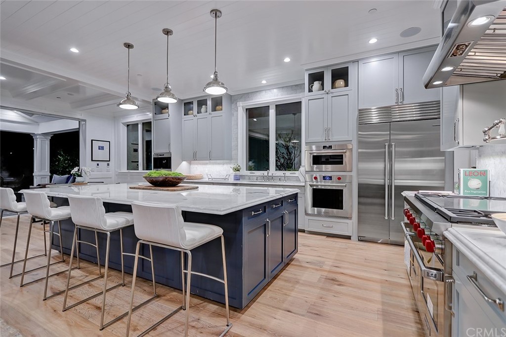 1751 8th Street Manhattan Beach, CA 90266 - Photo 9 of 43 a kitchen with stainless steel appliances kitchen island granite countertop a table chairs and a refrigerator