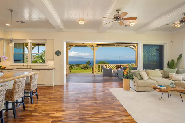 a living room with furniture and a view of dining room