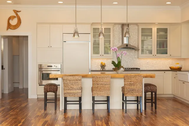 a kitchen with a table chairs refrigerator and cabinets