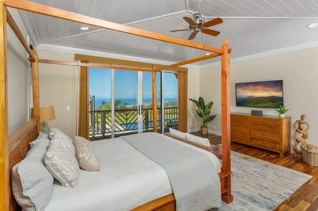 a bedroom with a bed and large windows