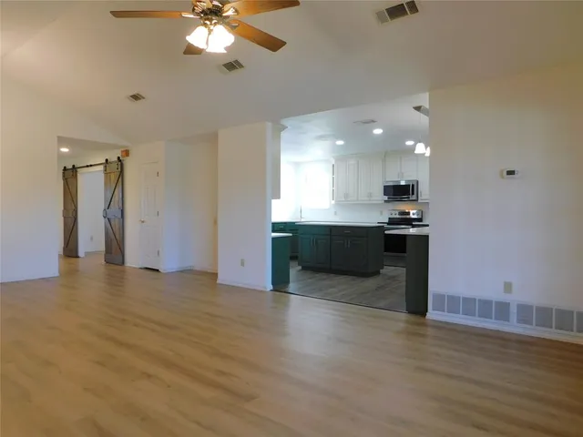 a view of kitchen with cabinets and wooden floor