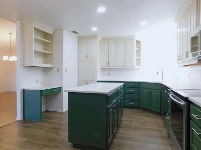 a kitchen with stainless steel appliances granite countertop a stove and a sink