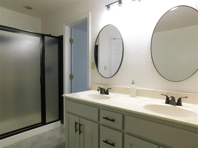 a bathroom with a double vanity sink and a mirror