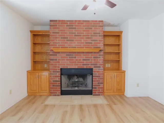 a view of an empty room with a fireplace