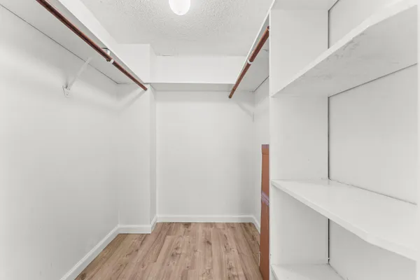 a view of hallway with stairs and wooden floor