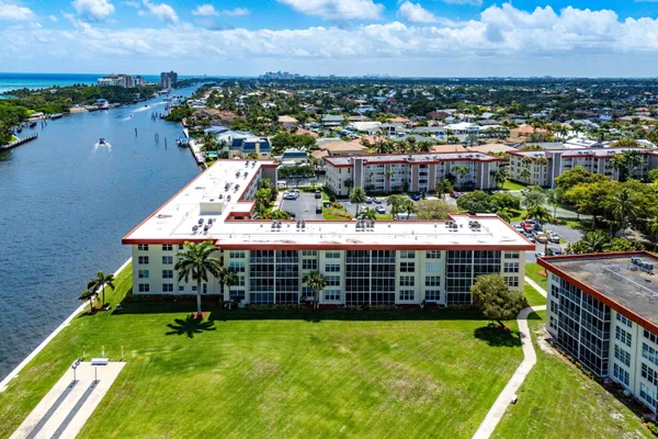 an aerial view of a house with a garden and lake view