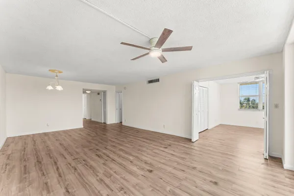 a view of empty room with wooden floor