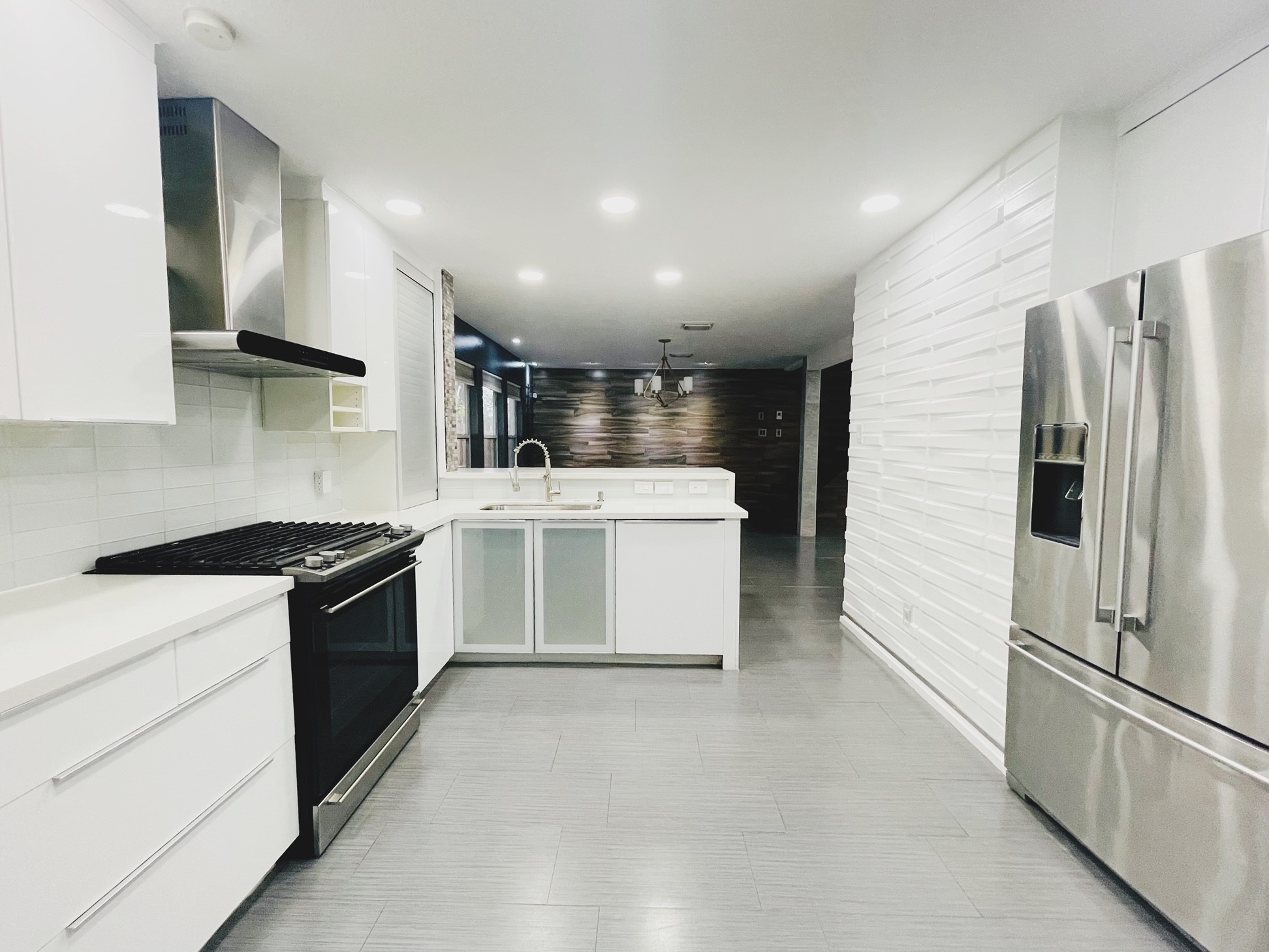 a kitchen with a stove top oven and cabinets
