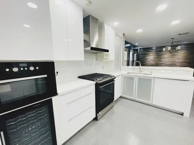 a kitchen with a stove and a refrigerator