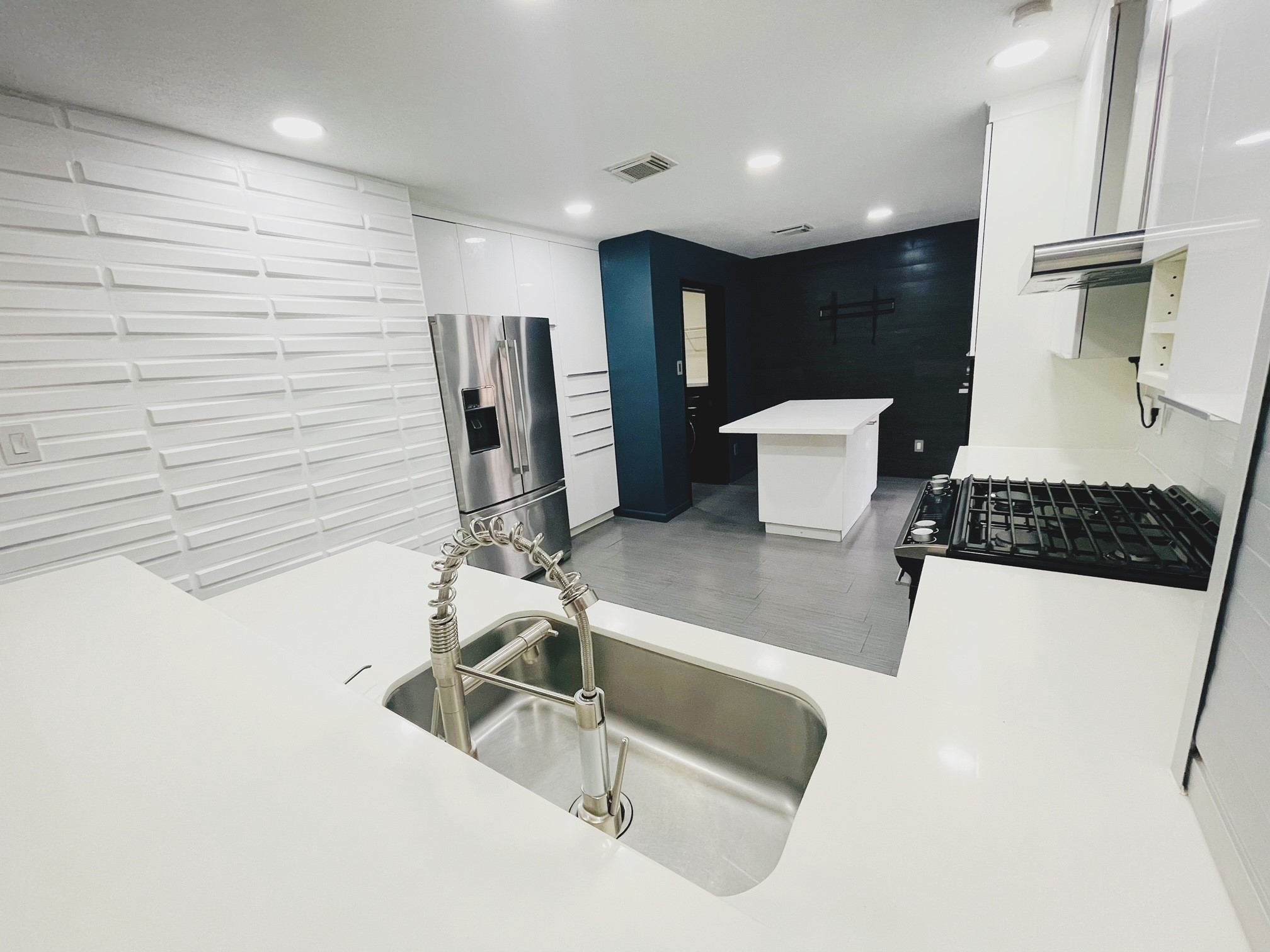 19639 River Bottom Road Katy, TX 77449 - Photo 8 of 36 a kitchen with a sink and a stove top oven
