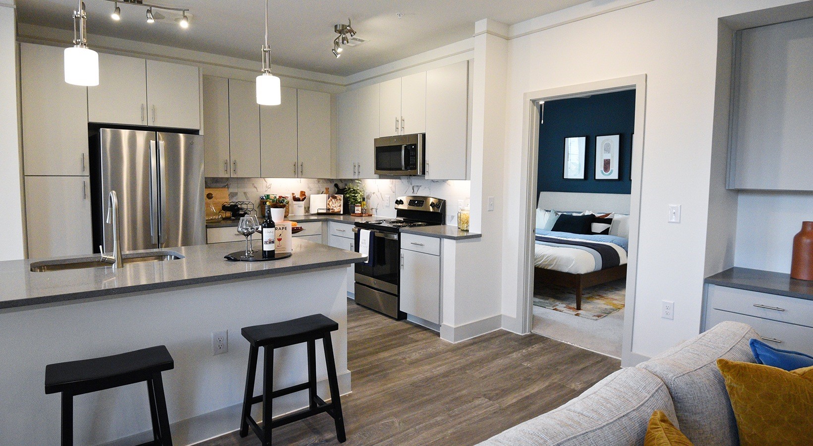 1700 Katy Fort Bend Road, Unit 8309 Katy, TX 77493 - Photo 26 of 30 a kitchen with cabinets and wooden floor