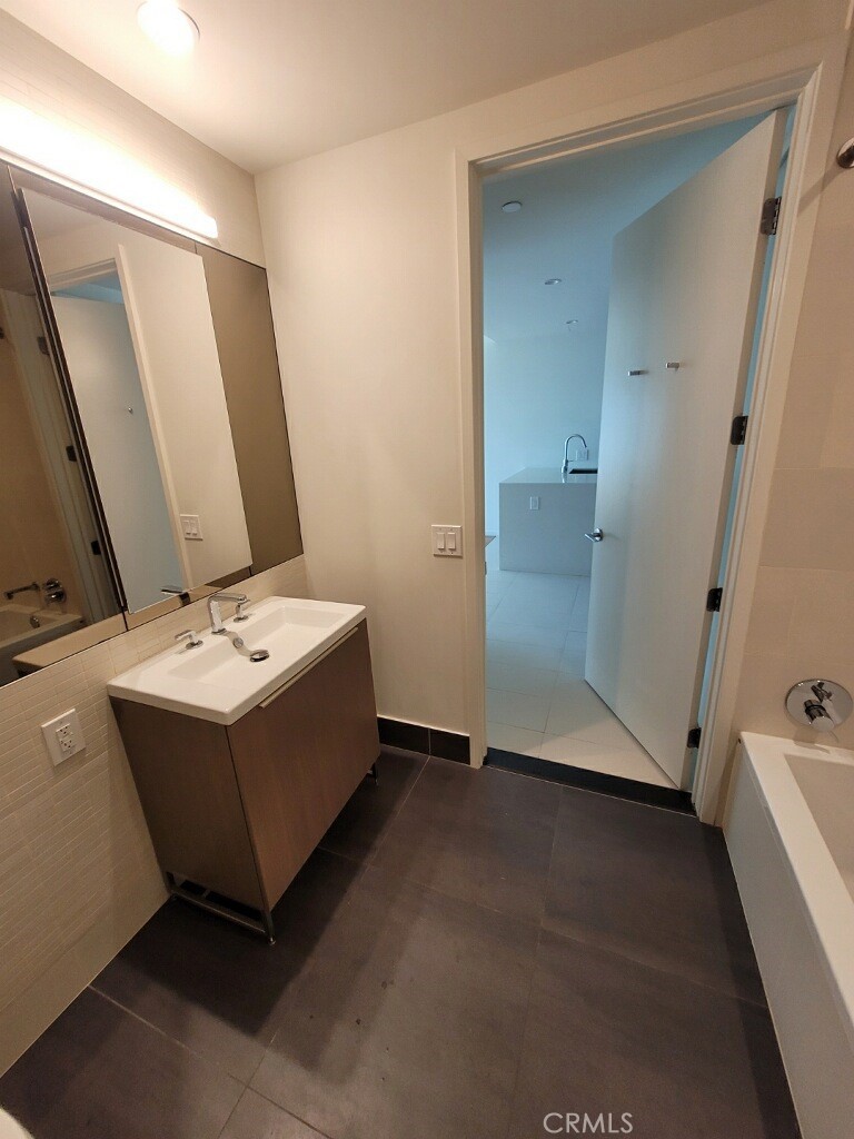 889 Francisco Street, Unit 3702 Los Angeles, CA 90017 - Photo 11 of 22 a bathroom with a sink and mirror