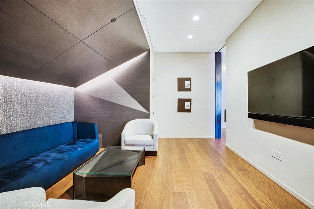 889 Francisco Street, Unit 3702 Los Angeles, CA 90017 - Photo 17 of 22 a living room with furniture and a flat screen tv