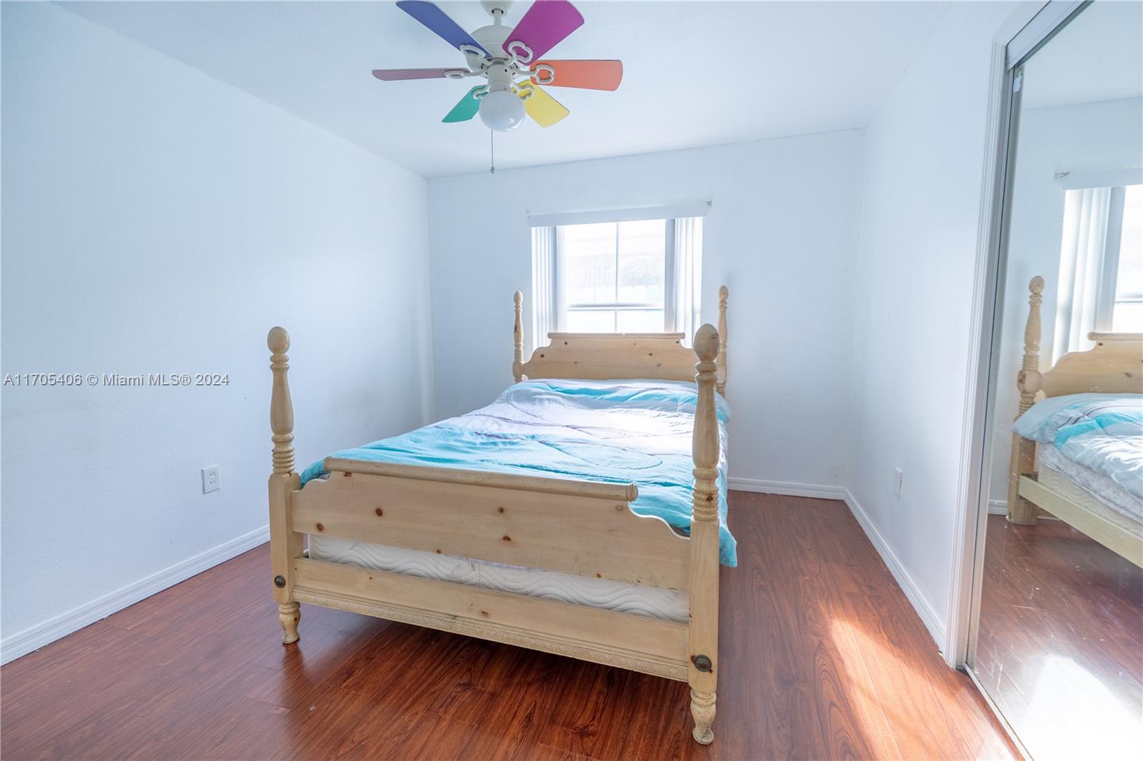 24622 Southwest 112th Court Homestead, FL 33032 - Photo 12 of 22 a bedroom with a bed and a window