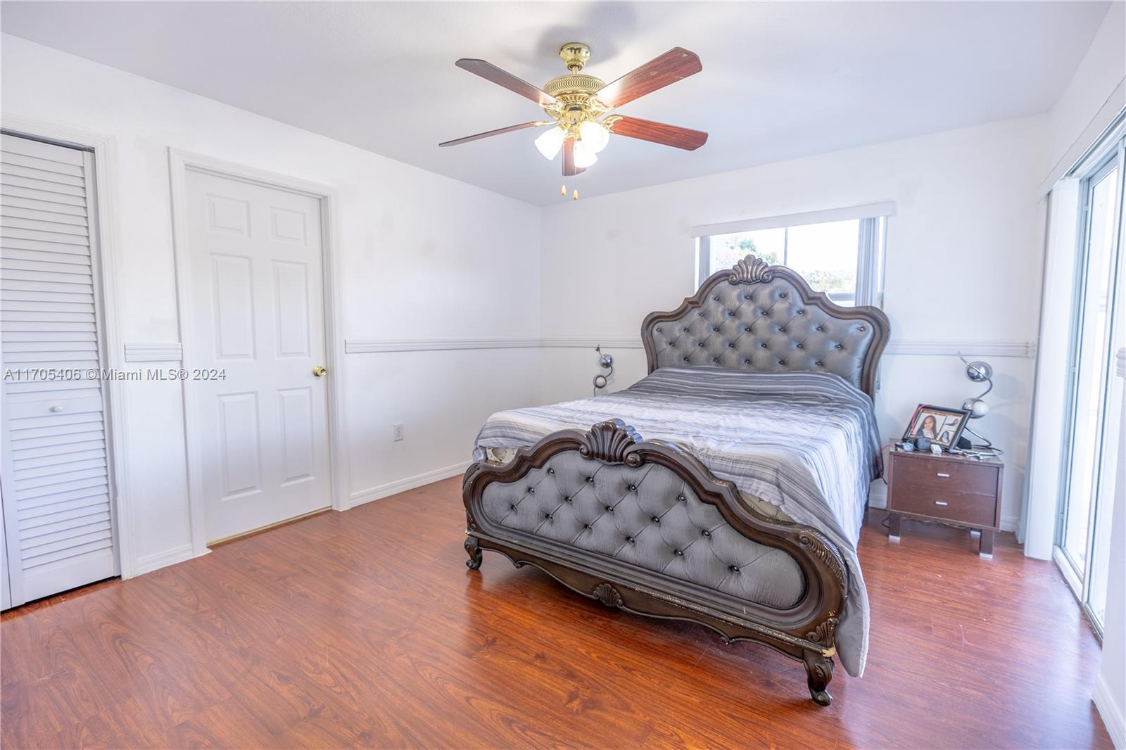 24622 Southwest 112th Court Homestead, FL 33032 - Photo 14 of 22 a bedroom with a bed and a ceiling fan