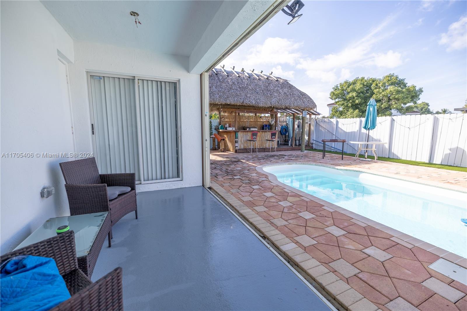 24622 Southwest 112th Court Homestead, FL 33032 - Photo 18 of 22 a view of a living room and kitchen with furniture and a tub