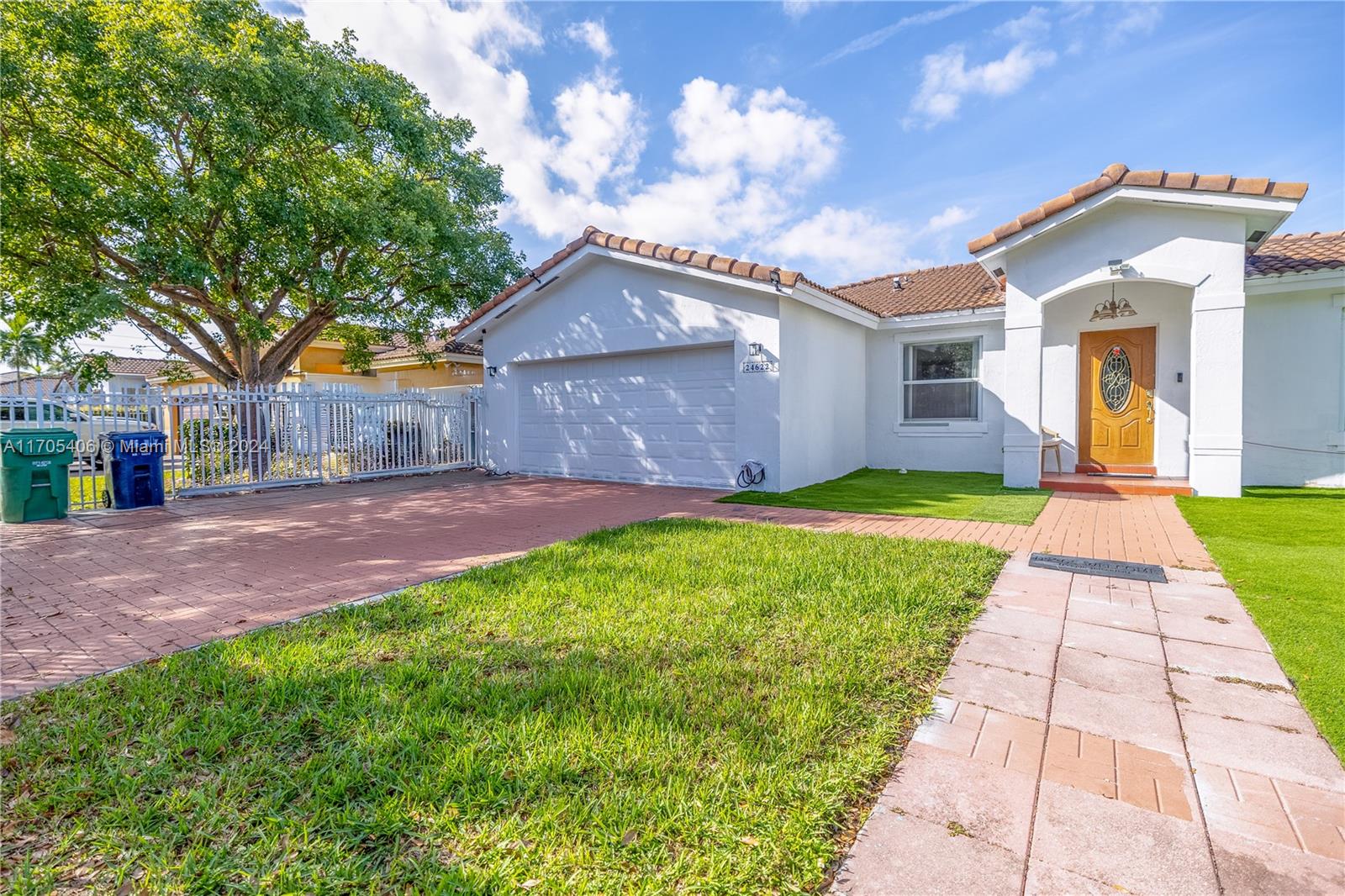 24622 Southwest 112th Court Homestead, FL 33032 - Photo 2 of 22 a front view of house with yard and green space