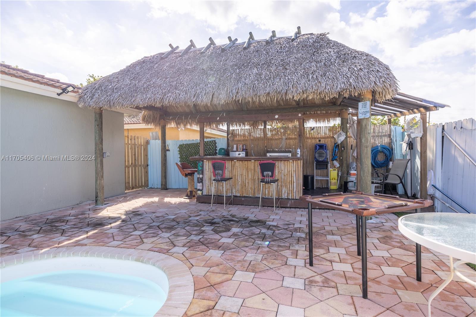 24622 Southwest 112th Court Homestead, FL 33032 - Photo 21 of 22 a patio with a table and chairs