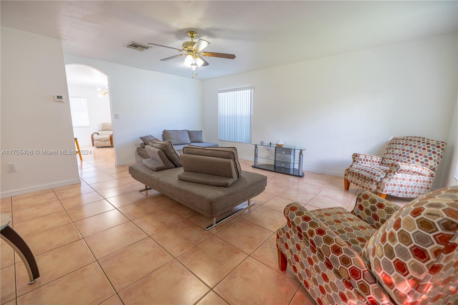 24622 Southwest 112th Court Homestead, FL 33032 - Photo 3 of 22 a living room with furniture and a chandelier