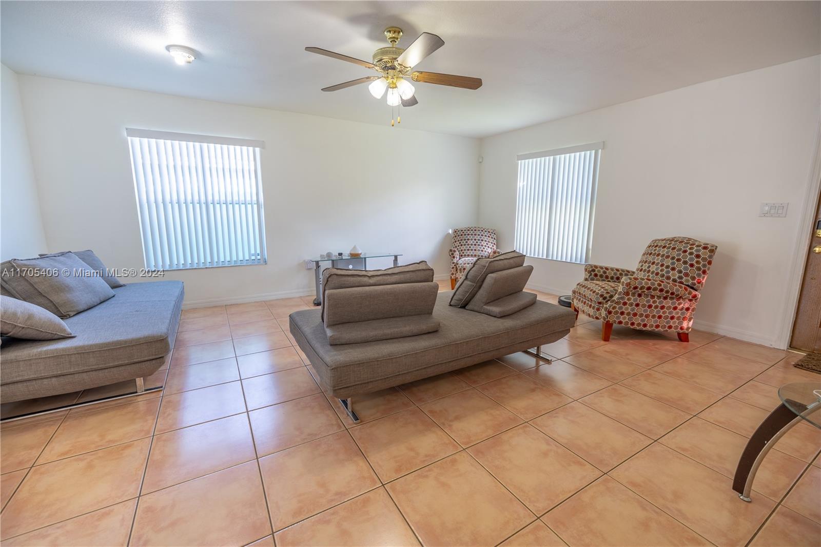 24622 Southwest 112th Court Homestead, FL 33032 - Photo 5 of 22 a living room with furniture and a ceiling fan