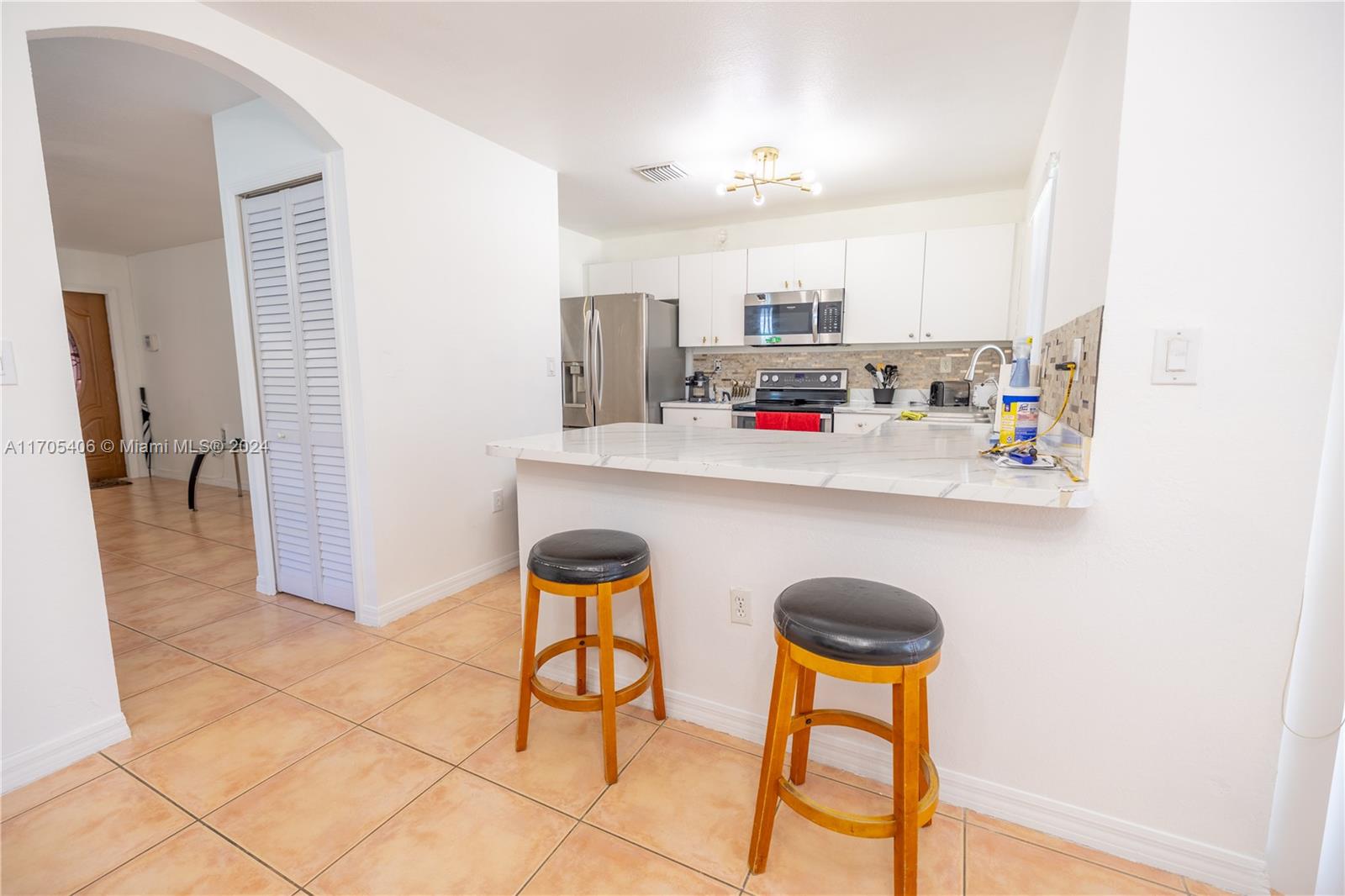 24622 Southwest 112th Court Homestead, FL 33032 - Photo 8 of 22 a kitchen with stainless steel appliances granite countertop a sink and a refrigerator