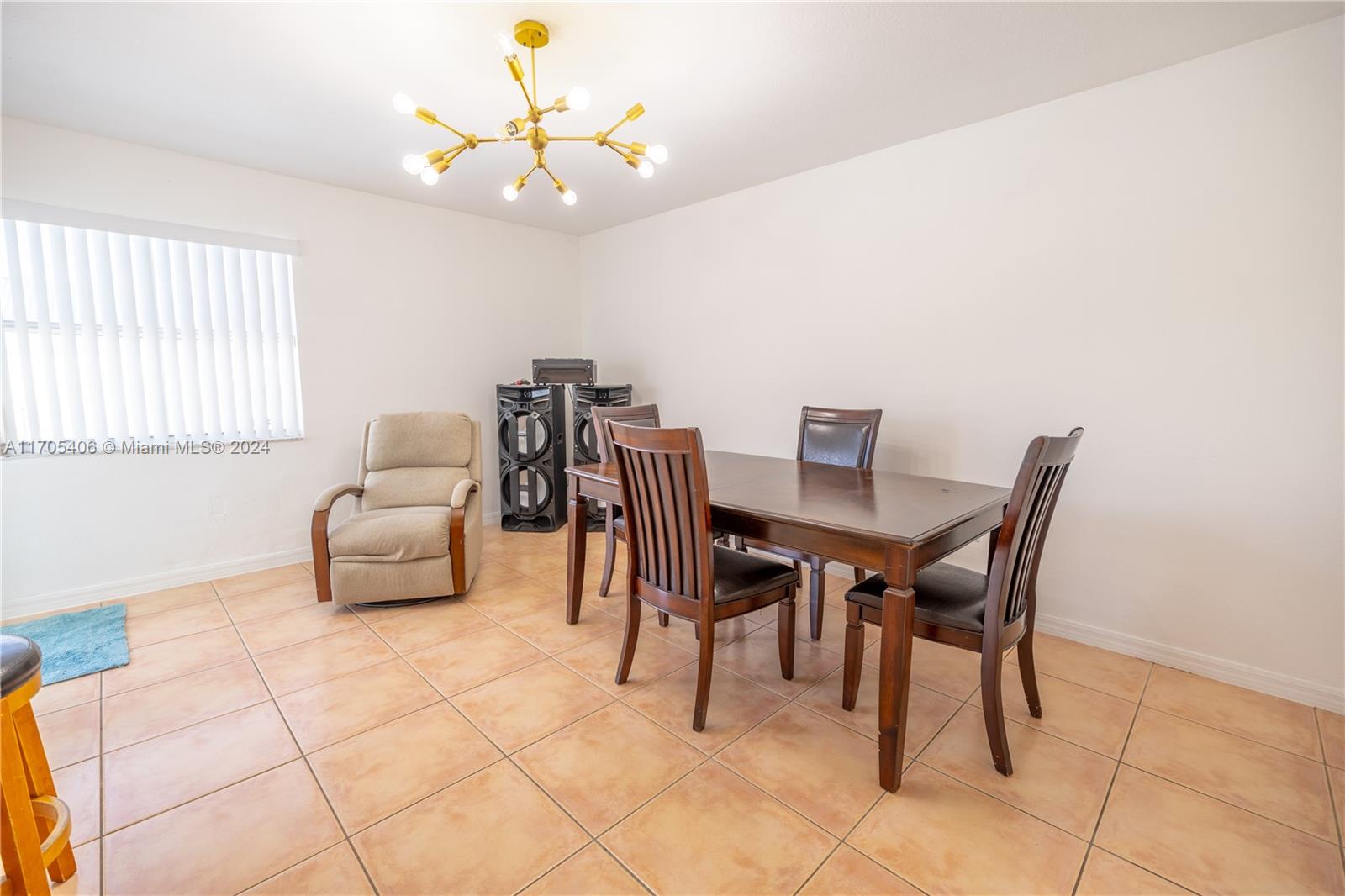 24622 Southwest 112th Court Homestead, FL 33032 - Photo 10 of 22 a dining room with furniture and a chandelier fan
