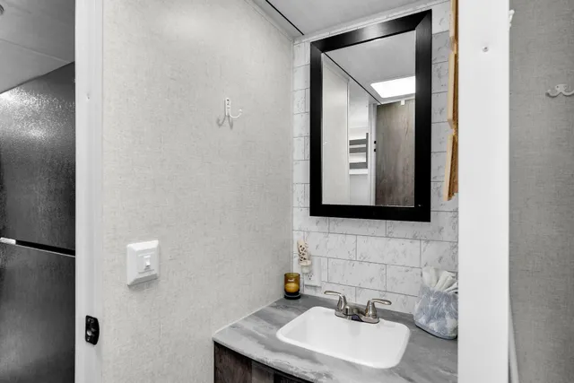 a bedroom with a bed and a ceiling fan