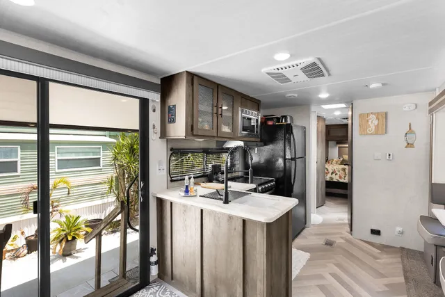 a kitchen with stainless steel appliances granite countertop a sink refrigerator and cabinets