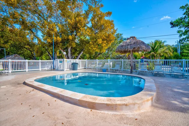 a view of a house with a wooden deck and a yard