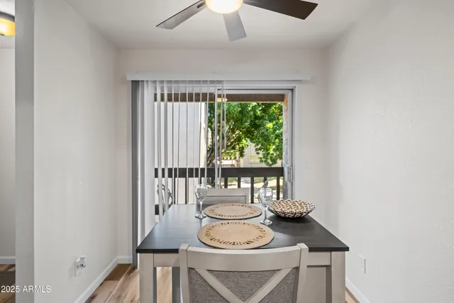 a dining room with furniture and wooden floor