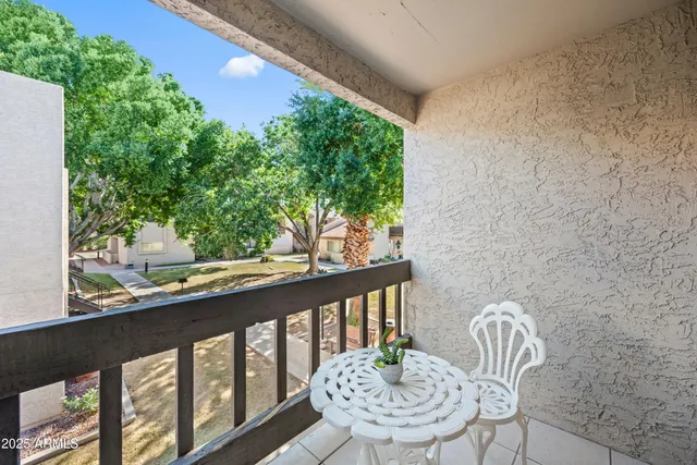 a view of a balcony with a table and chairs