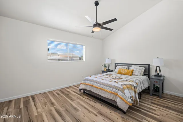 a bedroom with a bed and wooden floor