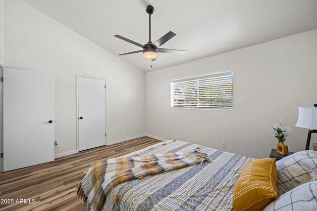 a bedroom with a large bed and a window