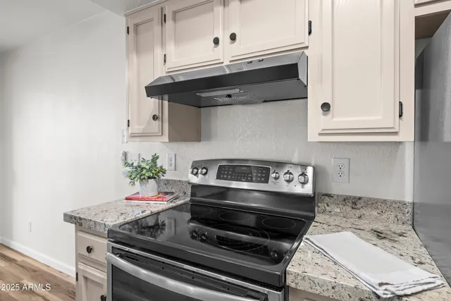 a stove top oven sitting inside of a kitchen
