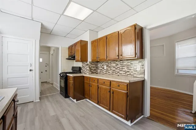 a kitchen with a refrigerator stove and sink