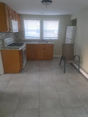 a kitchen with cabinets and window