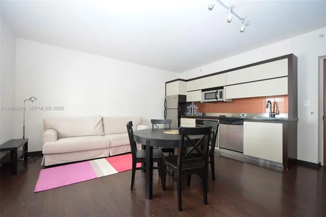 a view of a dining room with furniture and wooden floor