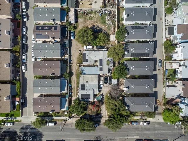 an aerial view of residential houses with outdoor space