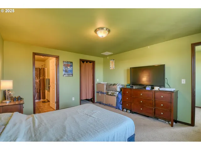 a bedroom with a bed and a flat screen tv